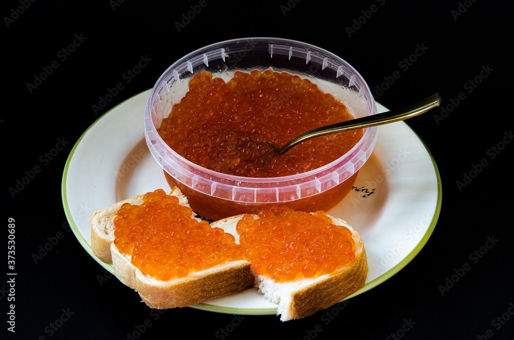 red caviar on sandwiches and in a jar red caviar on sandwiches and in a jar