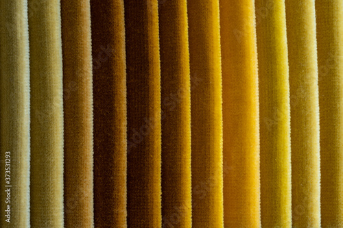 Abstract folded yellow colored velvet fabric photo