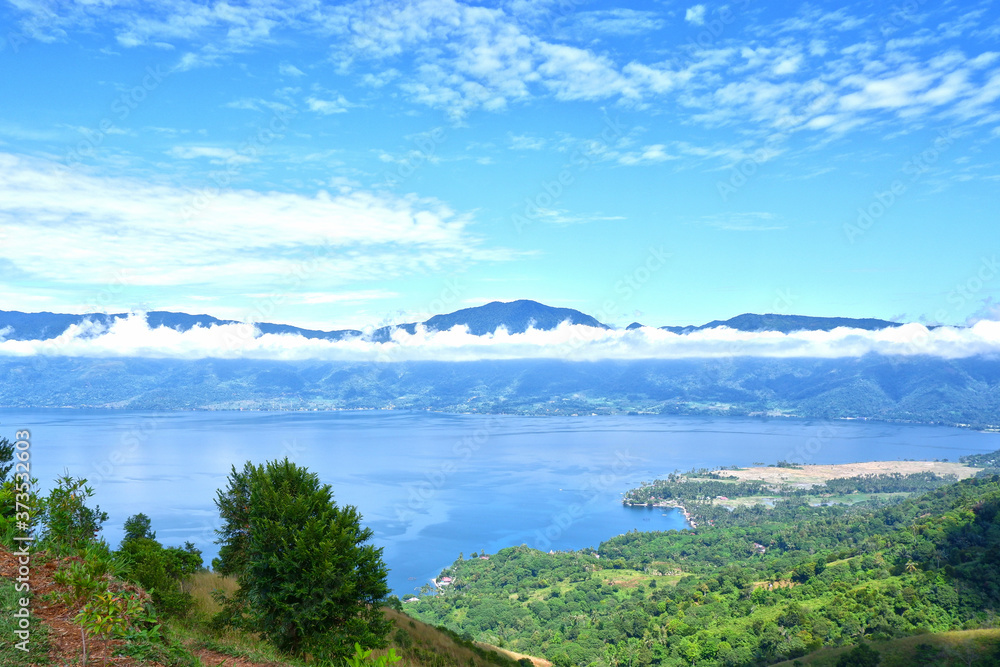 Beautiful scenery of hills and lakes with blue sky on a sunny day from Aua Sarumpun peak