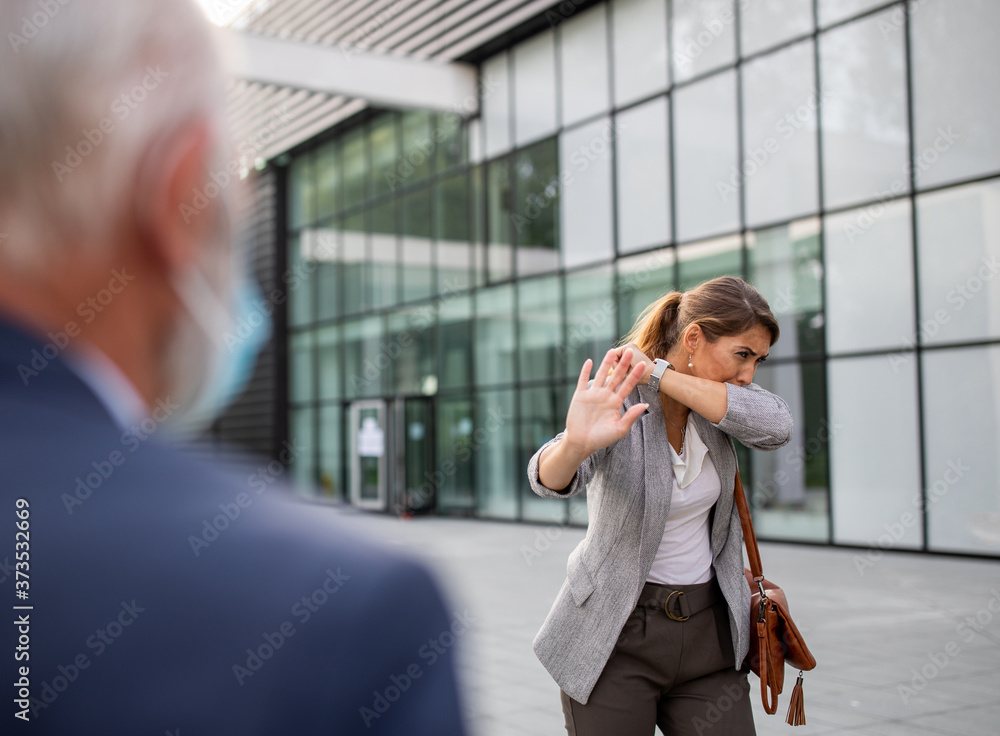 Busniess woman stopping man because of her cough Busniess woman stopping man because of her cough