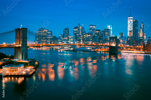 New York City at dusk with Brooklyn Bridge.