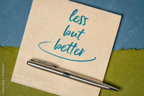 less but better - essentialism concept, handwriting on a napkin, lifestyle and personal development photo