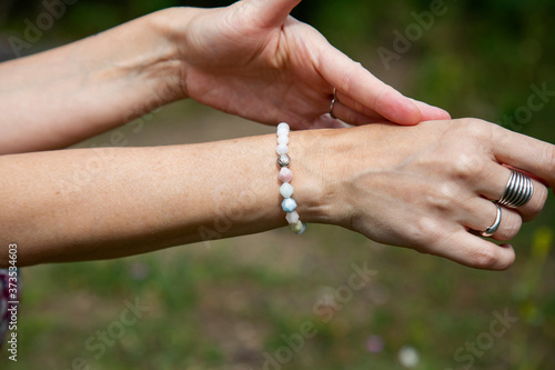 Outdoor closeup dancing hands with morganite bracelet