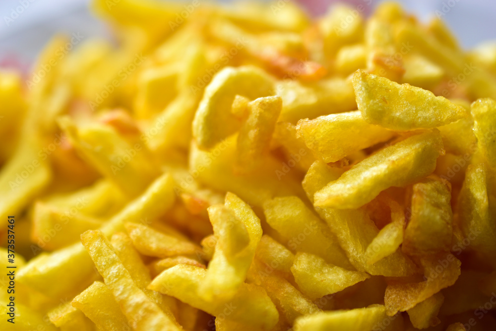 Freshly fried delicious French fries on a white plate Freshly fried delicious French fries on a white plate