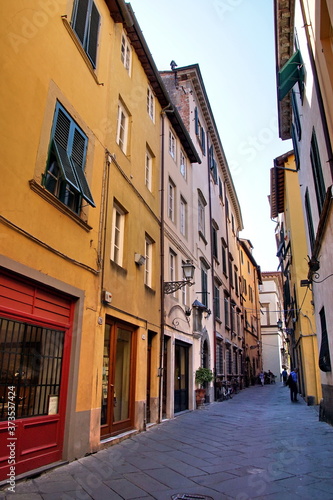 Narrow residential street in the historic part of Lucca, Italy © otmman
