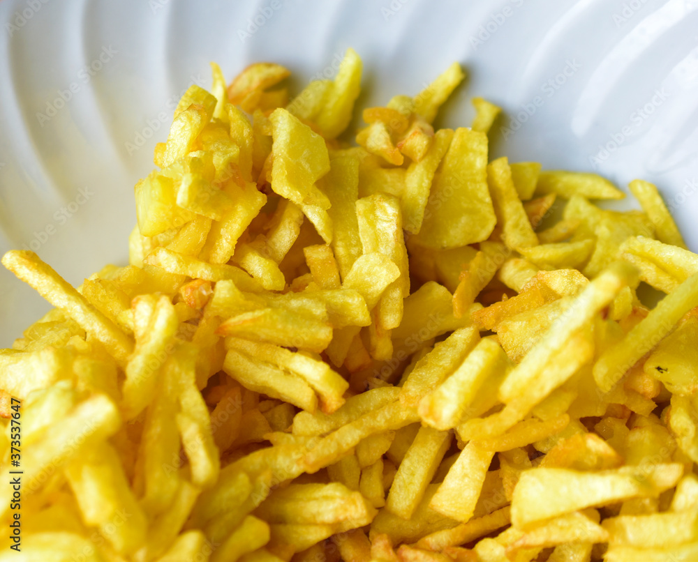 Freshly fried delicious French fries on a white plate Freshly fried delicious French fries on a white plate