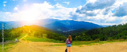 Panorama view of mountains. Girl in mountains. Hipster travelling. Beautiful landscape. Sky with clouds. Amazing nature. Wanderlust concept.