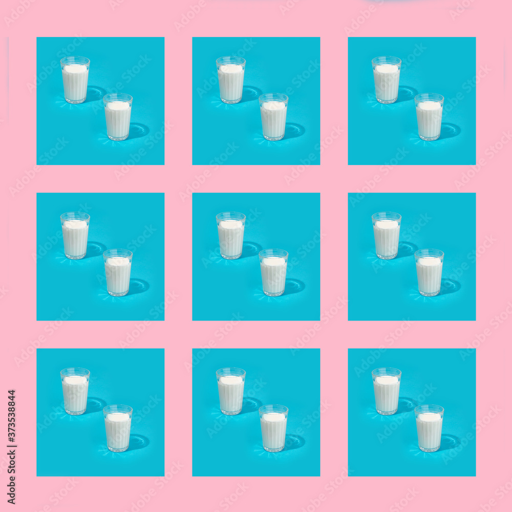 Pattern milk in a glass on a pastel blue and pastel pink background.