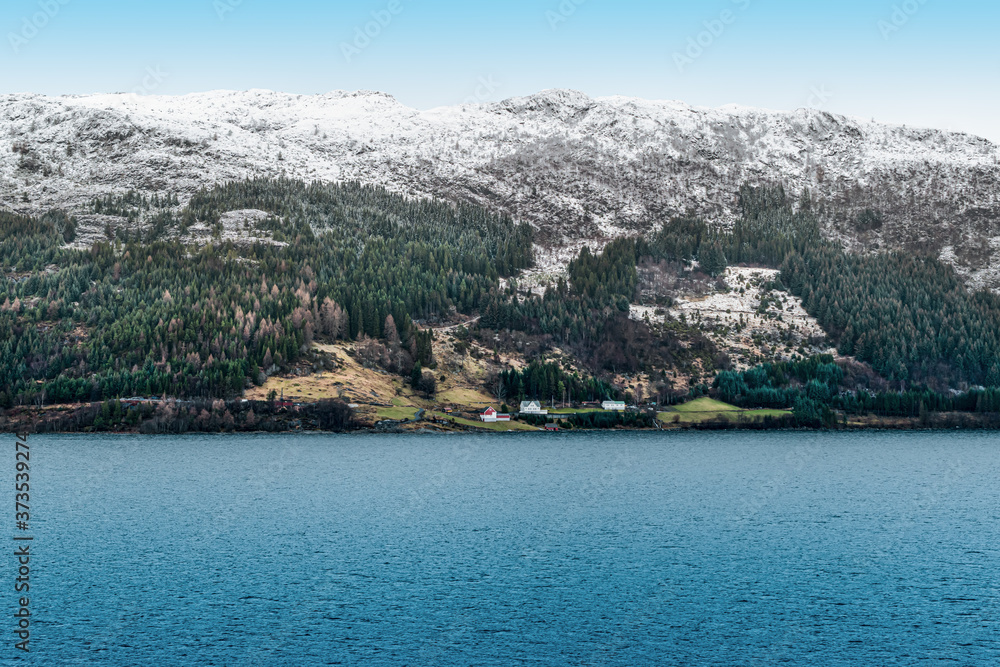 Snowy mountains along the coastline of Norway, Scandinavia.