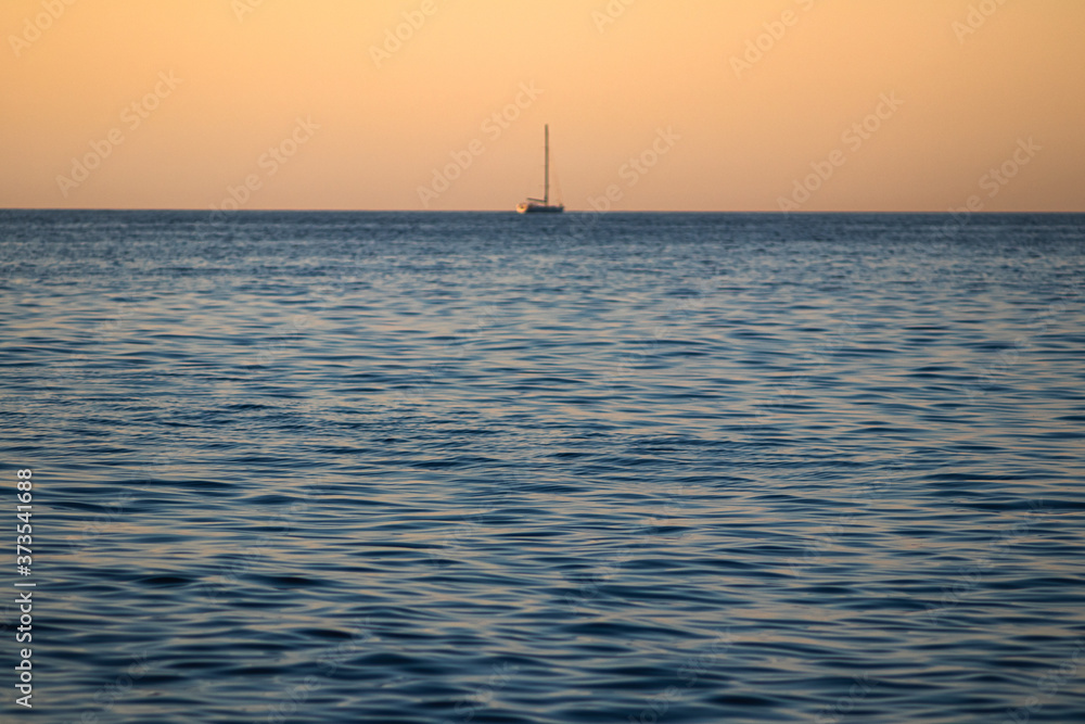 sea ripples and sailboat on blur backgraund