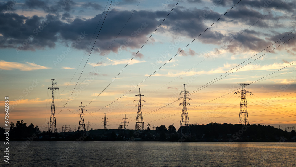 Panorama of the sunset with power lines on the river Bank, Russia, Ural