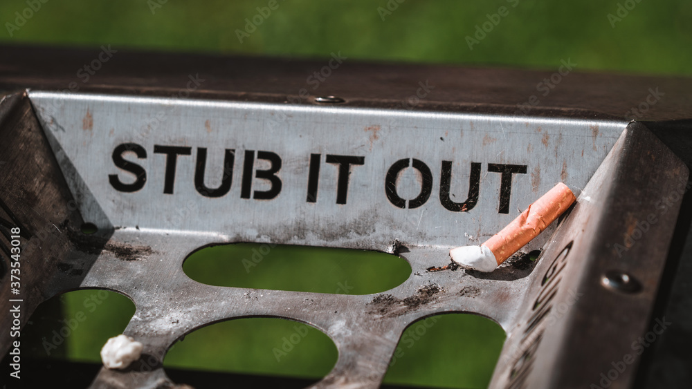 Obraz premium Stub it out - close up of a cigarette stub on a waste bin