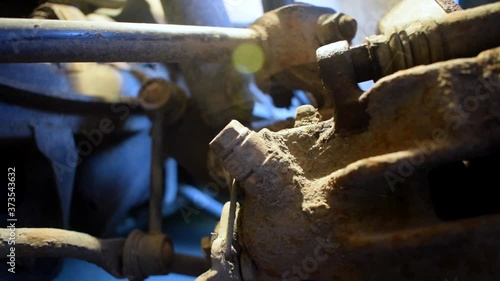 Unscrewing a bolt by hand on a brake caliper