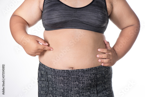 Fat women has overweight. she shows excess fat of the abdomen. isolated on white background.
