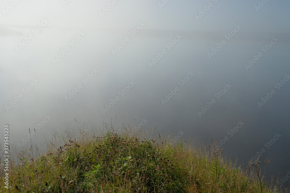 early morning, fog over the river. View from the high Bank early morning, fog over the river. View from the high Bank