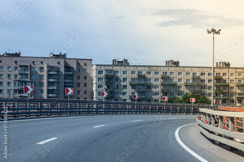 Residential buildings under the road. Bridge in the city.