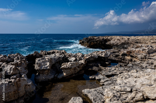 Waves crash on the rocky shore of the Mediterranean Sea on the Akamas Peninsula in the northwest of the island of Cyprus. © fifg