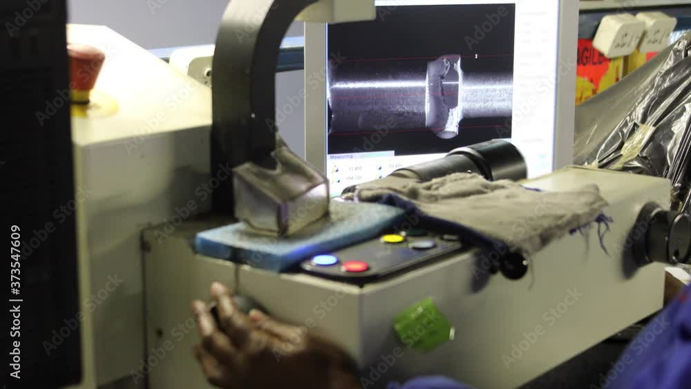 African woman working on a cutting polishing machine for diamonds African woman working on a cutting polishing machine for diamonds