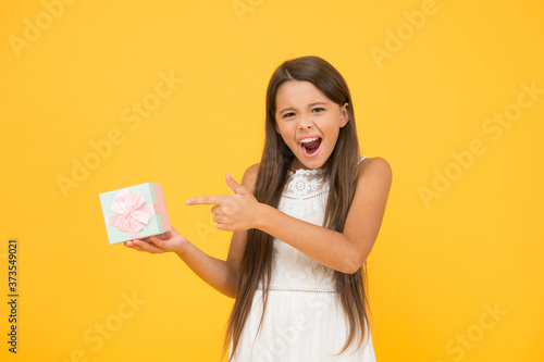 In shopping store. little shopaholic with purchase. vacation time. small girl hold present box. fashion and beauty. childhood happiness. happy childrens day gift. female beauty go shopping