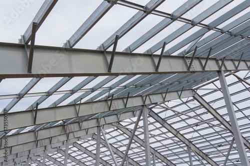 Steel beams on blue sky background. Industrial background.