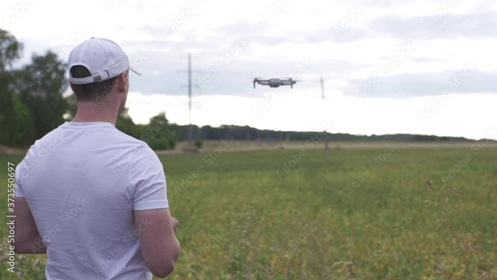 custom made wallpaper toronto digitalFarmer in a cap uses a drone to fly over a field of soybean. Farmer uses a controller to control the drone. Modern technologies in agriculture