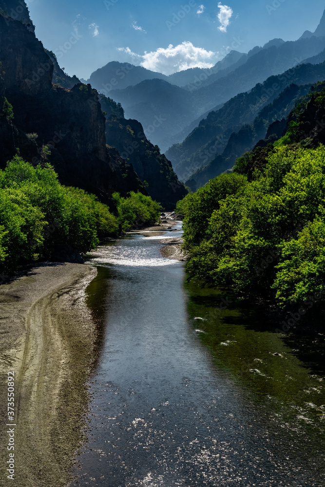 Fototapeta premium Impressive natural landscape in the ravine of the river Aoos that crosses the mountain range of Pindos. Very high steep peaks, wild flora, rapidly gushing waters all taken from Greek mythology.