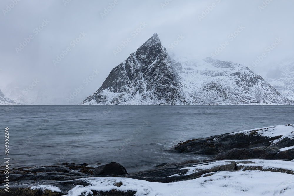 Famous Olstinden peak in a moody condition. Lofoten Islands, Norway