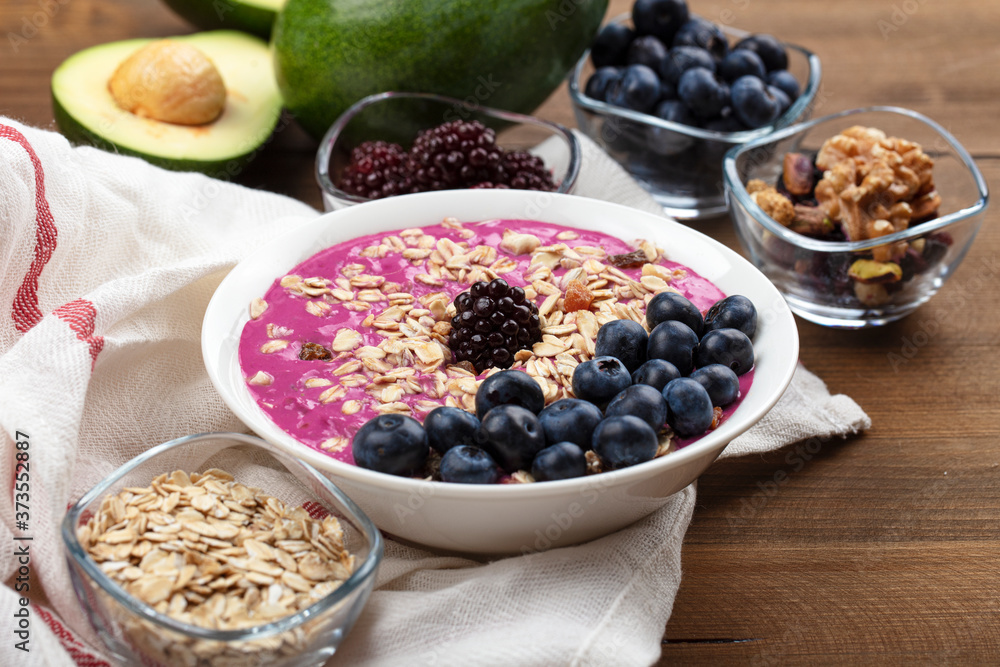 Breakfast bowl with cereals, fruit, oats, blueberries. Healthy morning meal on a wooden background. Top view. Breakfast bowl with cereals, fruit, oats, blueberries. Healthy morning meal on a wooden background. Top view.