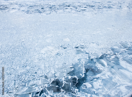 Фотография Ice on a river with cracked uneven surface