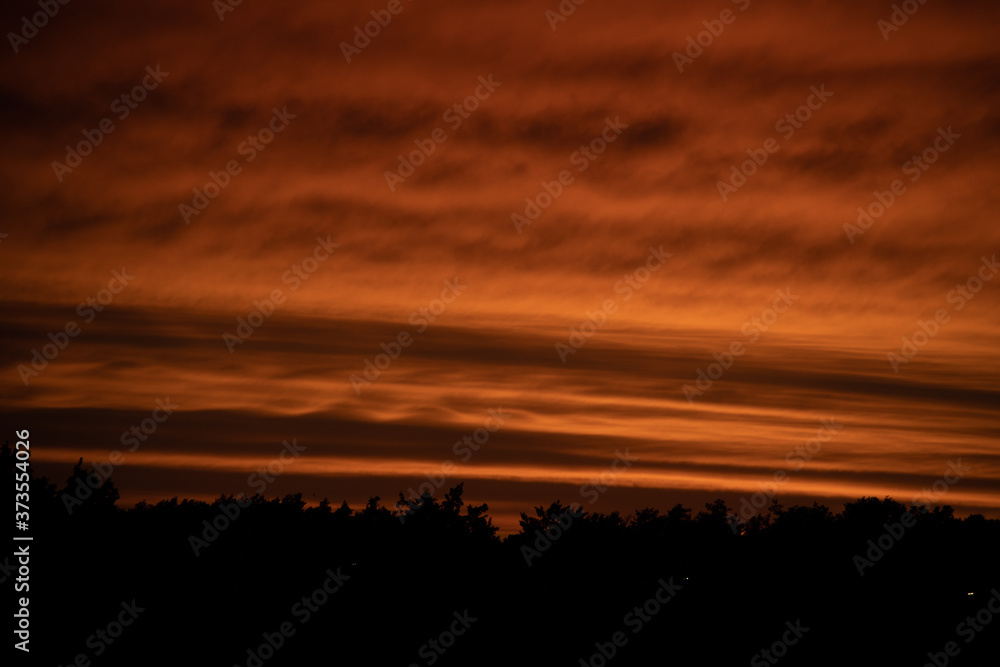 landscape with red sky clouds after sunset
