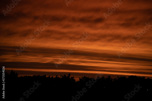 landscape with red sky clouds after sunset