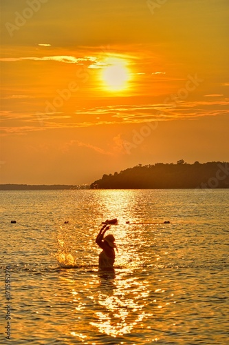 Fototapeta Naklejka Na Ścianę i Meble -  silhouette of a woman on a sunset at the beach