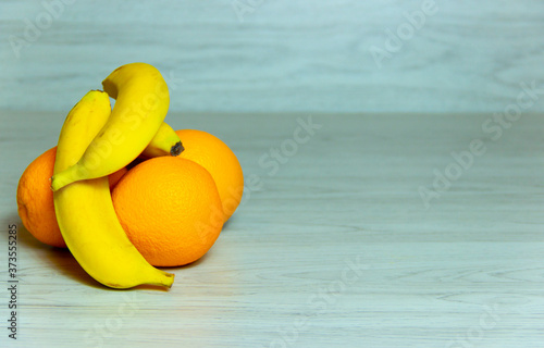 The group of fresh banan and orange on a table photo