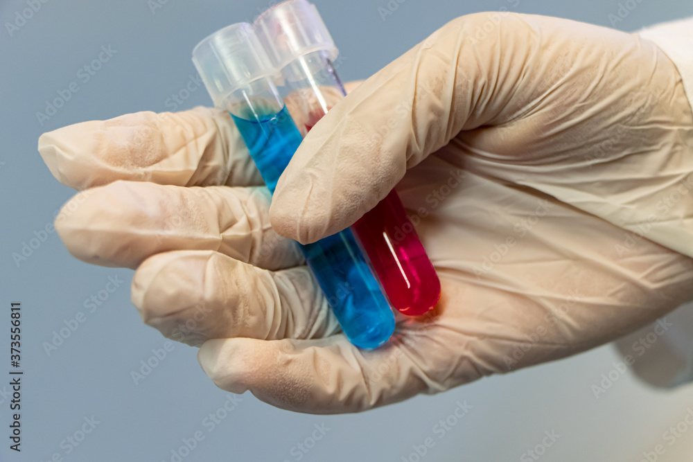 Hand holding tubes with colorful liquid Hand holding tubes with colorful liquid