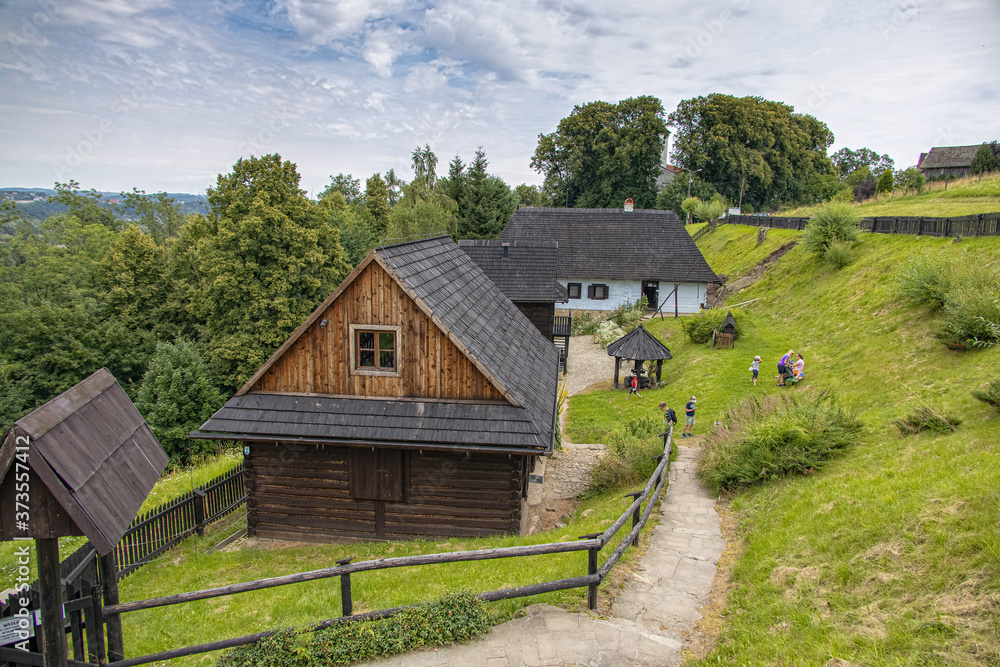 historic wooden rural buildings with an open-air museum in Dobczyce Polish mountains on a summer day