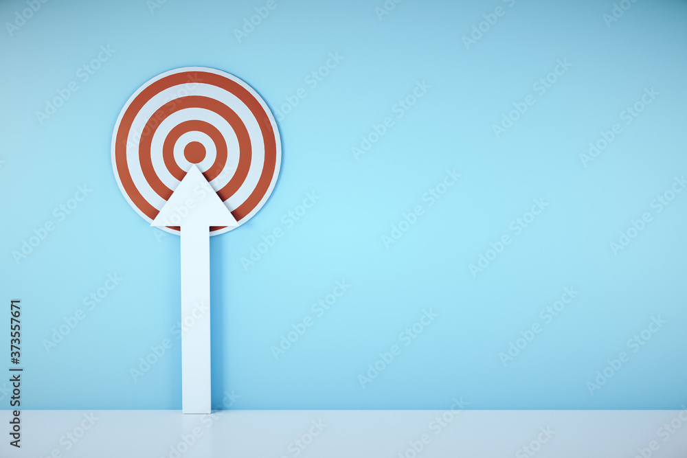 Red target with white arrow on blue wall. Red target with white arrow on blue wall.