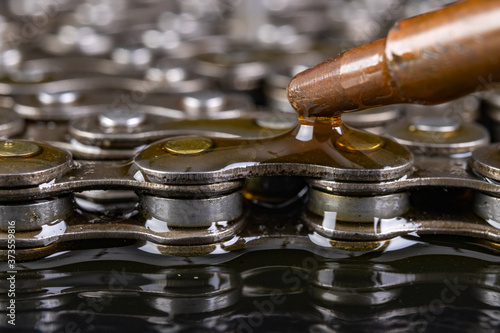 Lubricating the bicycle chain with oil from the oil can. Maintenance activities of bicycle gears.