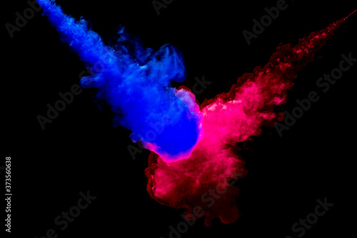 A cloud of red and blue paint released into clear water. Isolate on a black background.