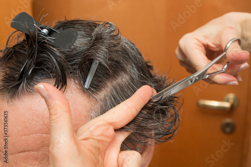 Senior Man getting a haircut at home. 