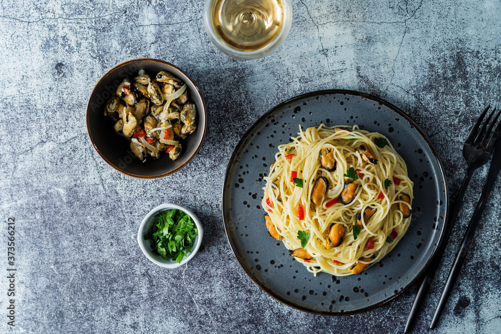 Mussel pasta with pepper and parsley in a plate Mussel pasta with pepper and parsley in a plate