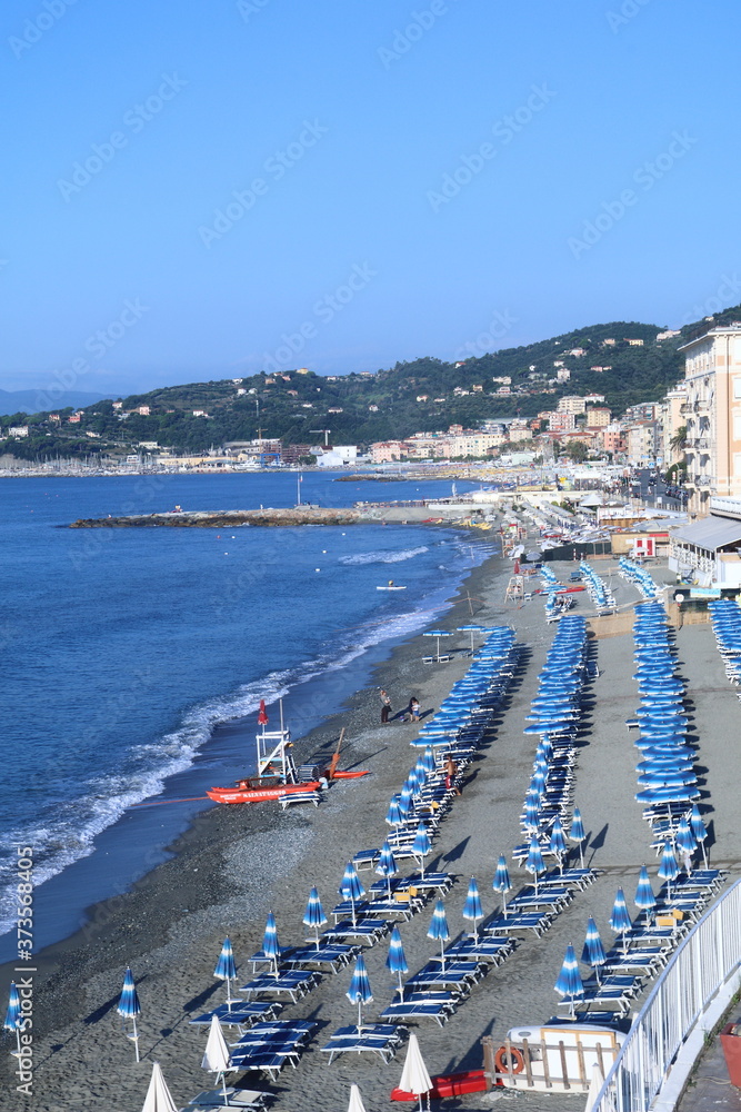 The beach and the houses of the Varazze promenade with the homonymous gulf in the background.Varazze is a town located in the western Ligurian Riviera, 30 kilometers from Genoa. 