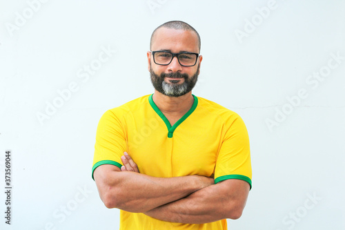 Brazilian soccer fan celebrating on white background