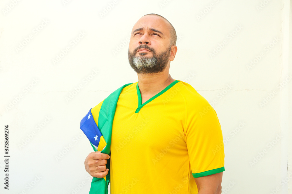 Brazilian soccer fan celebrating on white background