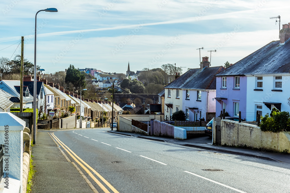 A view down the road leading into the seaside town of Tenby, Pembrokeshire on a sunny day