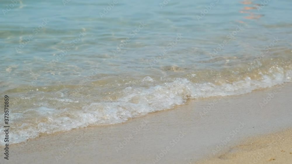Close up of sandy beach in summer sunny day. Small waves, soft waves on calm blue mediterranean sea or ocean. Calm pure water surface, happy summer vacation. Relax 4k video. Empty beach. Close up of sandy beach in summer sunny day. Small waves, soft waves on calm blue mediterranean sea or ocean. Calm pure water surface, happy summer vacation. Relax 4k video. Empty beach.