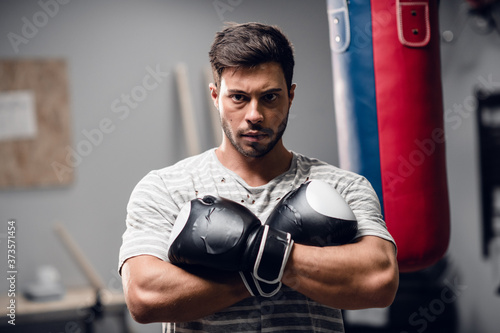 a young boxer warms up before a fight in the gym, adjusts to the fight © Anna Kosolapova