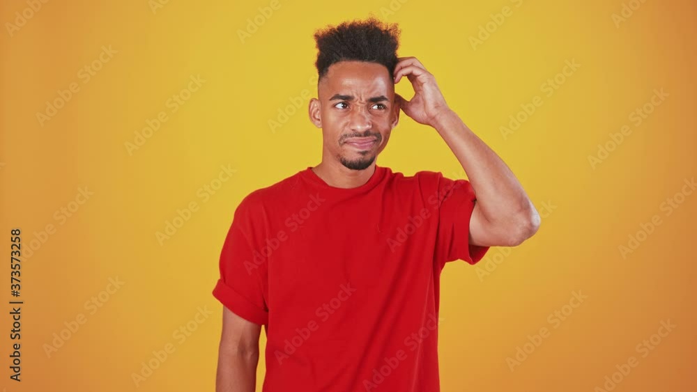 Doubtful black guy comparing decisions in head Doubtful black guy comparing decisions in head