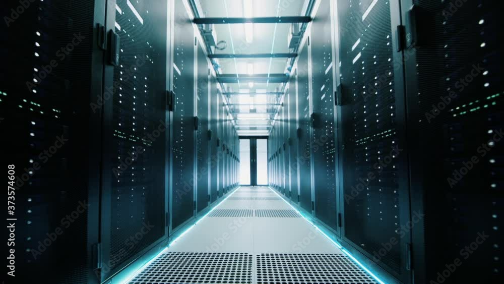 Network and data servers behind glass panels in a server room of a data center or ISP. Forward Dolly Shot