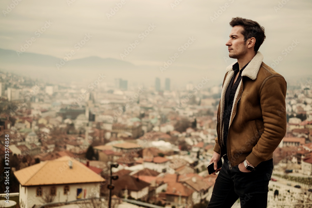 A handsome man in front of the city view