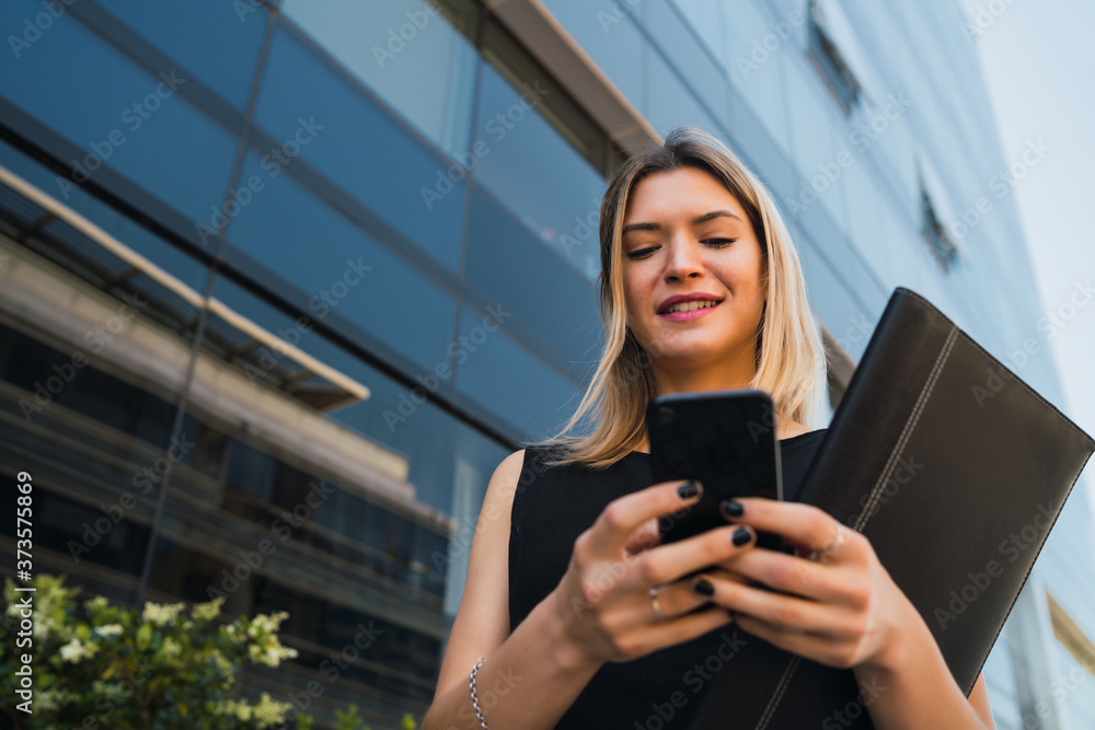 Business woman using her mobile phone.